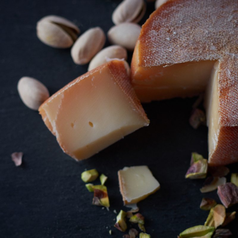 A cheese board with cheese and nuts